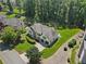 Aerial view of a stately home with a well-manicured lawn, mature trees, and a private driveway at 5706 Brookstone Nw Walk, Acworth, GA 30101