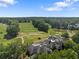 Aerial view of the golf course and country club with lush greenery and ponds at 5706 Brookstone Nw Walk, Acworth, GA 30101