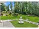 Beautiful backyard featuring an elegant white fountain and lush green lawn, creating a tranquil outdoor space at 5706 Brookstone Nw Walk, Acworth, GA 30101