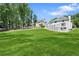 Spacious backyard features a well-manicured lawn and a charming white exterior of the home, perfect for outdoor activities at 5706 Brookstone Nw Walk, Acworth, GA 30101