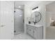 Bright bathroom with glass enclosed shower, granite counters, modern light fixture and decorative mirror at 5706 Brookstone Nw Walk, Acworth, GA 30101