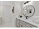 Bathroom with a modern vanity featuring a round mirror, white cabinets, and marble floors at 5706 Brookstone Nw Walk, Acworth, GA 30101