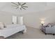 Neutral bedroom offers soft carpet, a ceiling fan, accent chair and ensuite bath access at 5706 Brookstone Nw Walk, Acworth, GA 30101