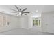Bright bedroom featuring plush carpeting, many windows, and a modern ceiling fan at 5706 Brookstone Nw Walk, Acworth, GA 30101