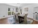 Bright dining room featuring a modern chandelier, a stylish table with seating for six, and a window view at 5706 Brookstone Nw Walk, Acworth, GA 30101
