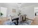 Elegant dining room features a modern chandelier, hardwood floors, neutral colors, and modern decor at 5706 Brookstone Nw Walk, Acworth, GA 30101