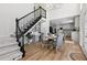 Elegant foyer with wood floors, staircase, chandelier, and adjacent dining area at 5706 Brookstone Nw Walk, Acworth, GA 30101