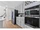Modern kitchen with stainless steel appliances, gray cabinets, and sleek backsplash at 5706 Brookstone Nw Walk, Acworth, GA 30101