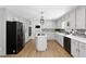 Spacious kitchen with stainless steel appliances, island, tile backsplash, and hardwood floors at 5706 Brookstone Nw Walk, Acworth, GA 30101