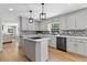 Spacious kitchen with island, stainless steel appliances, light gray cabinets, and hardwood floors at 5706 Brookstone Nw Walk, Acworth, GA 30101