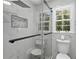 Modern shower with glass doors, marble tiling, and a rainfall shower head at 5706 Brookstone Nw Walk, Acworth, GA 30101