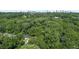 An aerial view of the property, surrounded by lush greenery, with city skyline in the distance at 805 Gertrude Nw Pl, Atlanta, GA 30318