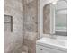 Bathroom featuring a tiled shower, modern vanity, and sleek finishes and fixtures at 805 Gertrude Nw Pl, Atlanta, GA 30318