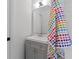 Chic bathroom with a gray vanity, stylish mirror, and a colorful towel accent at 805 Gertrude Nw Pl, Atlanta, GA 30318
