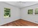 Bright bedroom with hardwood floors, ceiling fan, and large windows at 805 Gertrude Nw Pl, Atlanta, GA 30318