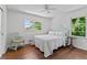 Bright bedroom with hardwood floors, neutral colors, a ceiling fan, and two windows at 805 Gertrude Nw Pl, Atlanta, GA 30318