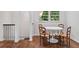 Dining area with hardwood floors, a white table and chairs adjacent to a stairway at 805 Gertrude Nw Pl, Atlanta, GA 30318