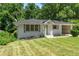 Charming single-story home with beautiful landscaping and a well-maintained lawn at 805 Gertrude Nw Pl, Atlanta, GA 30318
