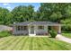 Charming single-story home with a well-manicured lawn and attached carport at 805 Gertrude Nw Pl, Atlanta, GA 30318
