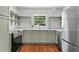 Well-lit kitchen with stainless steel appliances, sink beneath large window, and open shelving at 805 Gertrude Nw Pl, Atlanta, GA 30318