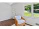 Cozy living room featuring hardwood floors, natural light, and a comfortable sitting area at 805 Gertrude Nw Pl, Atlanta, GA 30318
