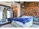 Stylish bedroom featuring a stone accent wall, large mirror, and ample closet space at 860 Peachtree Street Northeast Ne St # 811, Atlanta, GA 30308