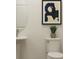 Stylish half bathroom features a pedestal sink and modern decor at 2276 Linden Pass, Douglasville, GA 30135
