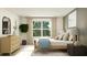 Bright bedroom featuring a large window, stylish dresser, and a comfortable bed at 2276 Linden Pass, Douglasville, GA 30135