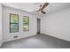 Neutrally decorated bedroom features a ceiling fan and view of the outside at 4771 N Springs Nw Rd, Kennesaw, GA 30144