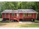 Charming ranch home featuring red wood siding, and a welcoming front porch and landscaped front yard at 4771 N Springs Nw Rd, Kennesaw, GA 30144