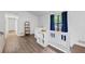 Bright hallway area with white trim, storage shelf and dark vinyl floors at 4771 N Springs Nw Rd, Kennesaw, GA 30144