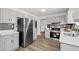 Well-lit kitchen featuring stainless steel appliances, white cabinets, and subway tile backsplash at 4771 N Springs Nw Rd, Kennesaw, GA 30144