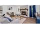 Bright living room with a stone fireplace, wood flooring, and neutral paint provides a cozy feel at 4771 N Springs Nw Rd, Kennesaw, GA 30144