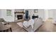 Cozy living room with a stone fireplace, wood mantel, and modern furnishings at 4771 N Springs Nw Rd, Kennesaw, GA 30144