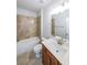 Cozy bathroom featuring tiled shower, tile floors, a vanity, and toilet at 5789 Creek Indian Dr, Sugar Hill, GA 30518