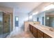 Bathroom with dual sink vanity, tiled floor, glass enclosed shower, and neutral tones at 5789 Creek Indian Dr, Sugar Hill, GA 30518
