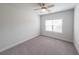 Neutral bedroom featuring carpeted floors and a window for natural light at 5789 Creek Indian Dr, Sugar Hill, GA 30518