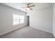 Cozy bedroom with carpet, ceiling fan, and a window bringing in natural light at 5789 Creek Indian Dr, Sugar Hill, GA 30518