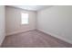 Neutral bedroom featuring carpeted floors and a window at 5789 Creek Indian Dr, Sugar Hill, GA 30518