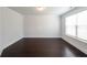 Clean bedroom featuring hardwood floors and a window with blinds at 5789 Creek Indian Dr, Sugar Hill, GA 30518