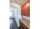 Hallway featuring dark hardwood floors, wainscotting, and granite countertops on wooden cabinetry at 5789 Creek Indian Dr, Sugar Hill, GA 30518