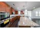 Bright, spacious kitchen with granite countertops and dark hardwood floors at 5789 Creek Indian Dr, Sugar Hill, GA 30518