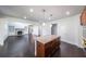 Open concept home featuring a kitchen island and dark wood floors at 5789 Creek Indian Dr, Sugar Hill, GA 30518