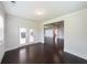 Open-concept living space featuring dark hardwood floors and access to an outdoor patio at 5789 Creek Indian Dr, Sugar Hill, GA 30518