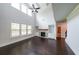Spacious living room with a fireplace, built-in bookshelves, and hardwood floors at 5789 Creek Indian Dr, Sugar Hill, GA 30518