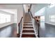 Staircase leading to open living space with cathedral ceiling and modern finishes at 5789 Creek Indian Dr, Sugar Hill, GA 30518