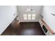 Bright living room showcasing dark hardwood floors, fireplace, and a ceiling fan at 5789 Creek Indian Dr, Sugar Hill, GA 30518