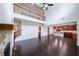 Open floor plan featuring a fireplace, dark wood floors, and a second-story balcony at 5789 Creek Indian Dr, Sugar Hill, GA 30518