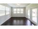 Sun-drenched sun room with three windows and glass doors to the backyard at 5789 Creek Indian Dr, Sugar Hill, GA 30518