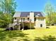 View of the rear exterior of the home with a large deck and solar panels on the roof at 96 Wildwood Dr, Temple, GA 30179